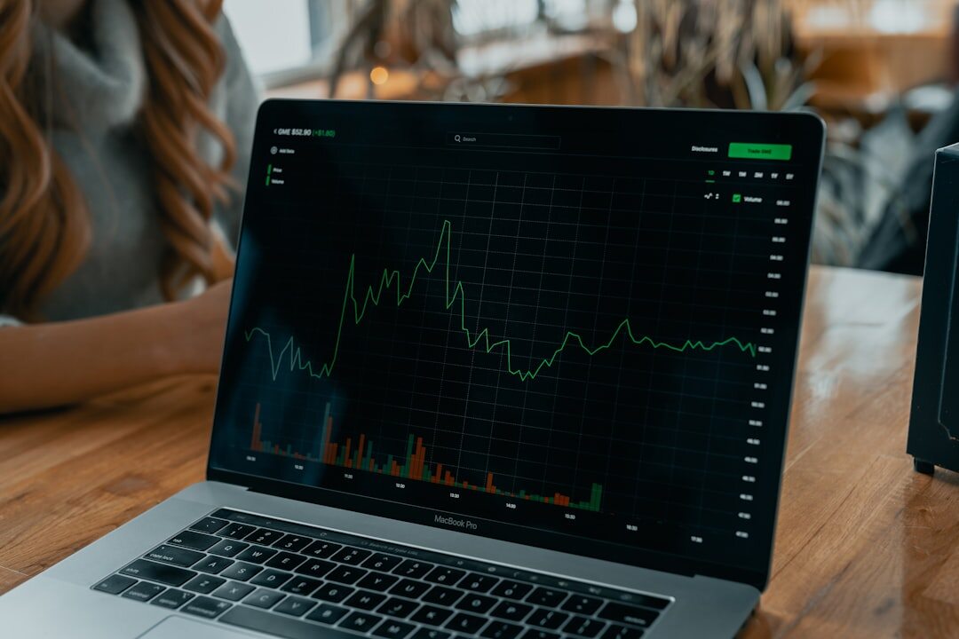 Open laptop showing data analytics dashboard with charts and graphs on screen