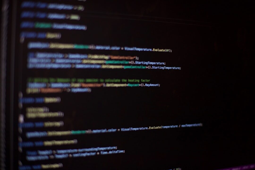 Developer writing code on computer screen with colorful syntax highlighting